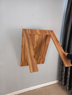 a wooden object hanging from the side of a wall