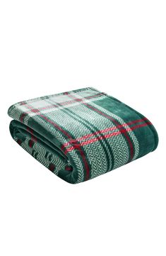 the green and red plaid blanket is folded up