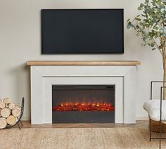 a living room with a fireplace and television mounted on the wall, next to a pile of logs