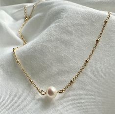 Elevate your style with our exquisite pearl necklace, a timeless piece that effortlessly combines classic elegance with a contemporary twist. Handcrafted with precision and attention to detail, this necklace is a stunning addition to your jewelry collection and a perfect choice for both everyday wear and special occasions. 🐚✨ Note: As each pearl is unique, slight variations in size, shape, and color may occur, ensuring that your necklace is truly one-of-a-kind. Finish: Gold Dipped Adjustable Ch Classic Pearl Clavicle Chain Necklace, Minimalist Pearl Pendant Jewelry With Round Beads, Dainty Everyday Pearl Chain Necklace, Classic White Pearl Drop Chain Necklace, Classic Pearl Necklaces With Delicate Chain, Classic Pearl Chain Necklace With Pearl Pendant, Minimalist Pearl Chain Necklace With Round Beads, Dainty Pearl Drop Chain Necklace For Everyday, Dainty Pearl White Chain Necklace With Pearl Charm