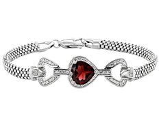 3.23ct heart shape Vermelho Garnet™ with .57ctw round white zircon, rhodium over sterling silver bracelet. Measures approximately .54"W. Lobster claw clasp. Accent stones primarily zircon. Elegant Sterling Silver Bracelet For Valentine's Day, Valentine's Day White Gold Sterling Silver Round Bracelet, Valentine's Day Formal Heart Bracelet With Diamond Accents, Fine Jewelry Silver Heart Diamond Bracelet, Fine Jewelry Silver Diamond Heart Bracelet, Silver Heart Bracelet With Diamond Accents, Silver Diamond Heart Bracelet, Valentine's Day Heart Bracelet With Diamond Accents, Silver Diamond Tennis Bracelet For Valentine's Day