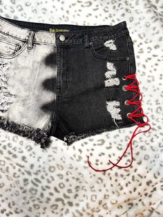 Feel the sssssizzle of summer in our super distressed leather laced denim shorts! These black denim shorts feature white acid wash patches, metal rivets and red leather lacing down the sides giving them a bold, stylish look. And don't forget the show-stopping snake print pocket on the back. Get ready to rock turn heads! Perfect for festivals or just everyday attitude. Women's size 13.  Handmade. Only one pair available. Lace Denim Shorts, Leather Lacing, Rock N Roll Style, Denim And Lace, Denim Shorts Women, Short En Jean, Distressed Leather, Black Denim Shorts, Rock N