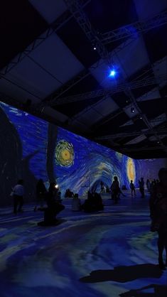 people are standing in front of an image of the starry night with bright lights