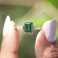 Emerald Cut Moissanite Ring | This 1.75 Ct Dark Green Moissanite Wedding Ring Features A Captivating Three-Stone Design With Tapper Baguette Moissanite Stones | Handcrafted With Love, This Exquisite Bridal Ring Is The Perfect Choice For Your Special Day.  ✥ 𝐅𝐢𝐧𝐝 𝐭𝐡𝐞 𝐦𝐚𝐭𝐜𝐡𝐢𝐧𝐠:  Band: https://www.etsy.com/listing/1226040576 ✥ 𝐌𝐚𝐢𝐧 𝐒𝐭𝐨𝐧𝐞 𝐃𝐞𝐭𝐚𝐢𝐥𝐬:  ↣ Shape:  Emerald  ↣ Type: Moissanite ↣ Weight: 1.70 CT (App.) ↣ Color/Clarity: Dark Green/VS ↣ Making Process: Handmade - Emerald Cut Ring With Wedding Band, Vvs Jewelry, Emerald Cut Moissanite Ring, Green Moissanite, Ring Three Stone, Moissanite Wedding Ring, Three Stone Engagement Ring, Emerald Cut Moissanite, Jewelry Details