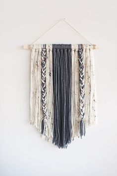 a wall hanging with several different colors of yarn