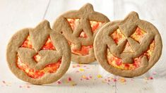 three cookies with different designs on them and sprinkles