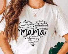 a woman wearing a white t - shirt with the words mama printed on it in different languages