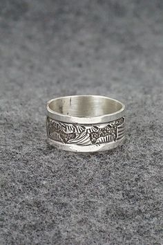 This sterling silver ring featuring a southwest landscape was made by Navajo silversmith Elaine Becenti. The inside is signed B and stamped sterling.Size: 11Width: 3/8"Free shipping on all orders! We ship with USPS and always include tracking. All orders ship within a day of payment.Returns are accepted up to 30 days after you receive your order. Just send us a message. Our shop offers cash back or store credit. The item must be returned in new condition. Artisan Sterling Silver Ring With Etched Details, Artisan Sterling Silver Etched Rings, Southwestern Silver Rings Collectible, Southwestern Silver Collectible Rings, Collectible Southwestern Silver Ring, Silver Southwestern Style Rings, Southwestern Style Untreated Silver Rings, Unique Stamped Antique Silver Rings, Bohemian Silver Stamped Rings