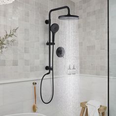 a shower head with thermostaer and handset is shown in this bathroom