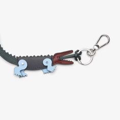 a keychain with two small blue elephants attached to it's leather cord