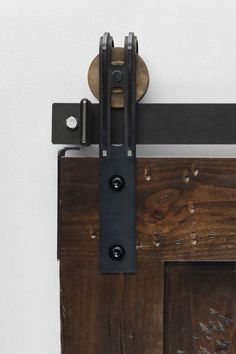 a close up of a wooden door with metal handles