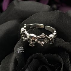 Embrace your Darker Side with this exquisite Skulls & Crossbones Adjustable Ring. Wear casual or dressy, whatever your heart desires. Enhance your Goddess look and pair with our Chokers, Necklaces, Bracelets, Rings, and Earrings. Details: 925 Sterling Silver Slightly Adjustable - fits sizes 7-9 best Width: 8mm Punk Style Metal Open Ring Jewelry, Adjustable Punk Metal Rings, Adjustable Metal Punk Rings, Punk Style Metal Open Ring, Adjustable Punk Style Metal Rings, Gothic Style Jewelry Metal Ring As Gift, Halloween Stainless Steel Ring Jewelry, Gothic Stainless Steel Metal Ring Jewelry, Punk Skull Rings As Gift