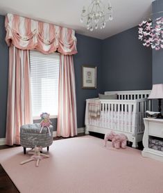 an image of a baby's room with pink and blue decor on the walls