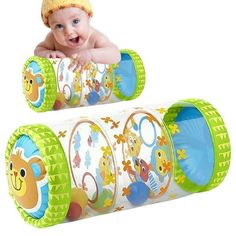 a baby laying on top of two tube toys