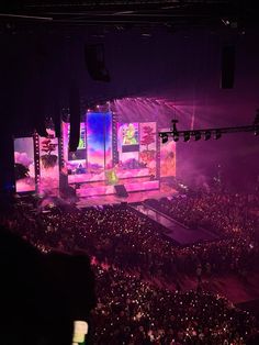 the stage is lit up with purple lights