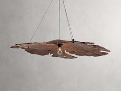 a wooden light fixture hanging from a ceiling