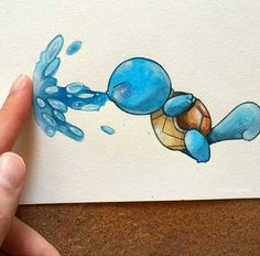 a drawing of a blue cartoon character is being held up