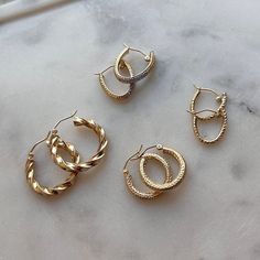 If you're looking for understated glam wrapped up in a all day-everyday essential, then you've found the perfect hoops! Our Ziggy Gold Hoops are THE must have for every look. These hoops will never lose their diamond cut luster. The perfect size and width for main character energy or layering with larger pieces. Always 14K Gold!

Size: 20mm (approx. 0.80" Inches) Diameter - 3mm (W)

Sold As PAIR
Ear Hook Snap Closure
Solid 14K Gold
Lifetime Guarantee
Made in Los Angeles Timeless Earrings, Shades Of Gold, Gold Piece, Earring Sale, Ear Hook, Main Character, Gold Hoops, Personalized Necklace, Diamond Cut