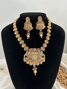 Antique gold real looking necklace with  earrings  Earrings length-  1.2 inches Style tip- Pair it with any beautiful traditional outfits  and flaunt with Unique style of collection from us. Perfect match for Festival and Traditional wear.  Take Care Tips-  Kee away from perfume, Hair spray and. Moisture.  Store in dry place , Ziplock bag or Airtight box.    Clean with dry cloth.  Jewellery is the last thing you should wear and first thing you should remove.  ------------------------------------ Gold Kundan Necklace With Stone Work For Festivals, Ceremonial Gold Kundan Necklace With Stone Work, Gold Kundan Necklace With Stone Work For Eid, Gold Chandbali Necklaces For Eid, Ornate Gold Kundan Jewelry Sets, Gold Chandbali Jewelry Sets, Gold Kundan Necklace Bollywood Style For Eid, Gold Kundan Chandbali Necklace With Stone Work, Ornate Gold Kundan Chandbalis