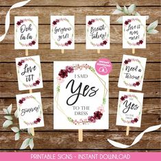 printable signs with flowers and greenery are displayed on a wooden background, including the words i said yes to the dress