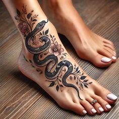 a woman's foot with a snake and flowers tattoo on the top of it