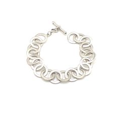 I am so happy to have come across a beautiful example of Canadian modern jewelry! This silver bracelet features a toggle closure and circle chain links. The piece is in excellent estate condition, showing minimal wear. Thank you so much and happy shopping! Elegant Sterling Silver Bracelet With Oval Link Toggle Clasp, Elegant Round Sterling Silver Bracelet With Toggle Clasp, Contemporary Metal Jewelry For Everyday, Contemporary Everyday Metal Jewelry, Elegant Link Bracelets With Jump Ring, Minimalist Silver Chain Bracelet With Sterling Clasp, Modern Silver Round Chain Bracelet, Everyday Sterling Silver Round Chain Bracelet, Silver Minimalist Metal Toggle Necklace