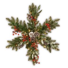 a christmas tree with pine cones and red berries on the branches is decorated with lights