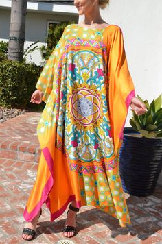 Make your day shine in this gorgeous, designer print silk caftan. Vibrant colors of orange, fuchsia and greens in a unique and special combinations of patterns with hints of gold embellishment throughout the pattern. A stunning garment for any occasion. Opaque fabric with no need of undergarment. One size. Fits medium to X-Large . Can be worn by many sizes. The width is 54 inches wide, edge to edge, or 108 inches around the body. The length is 52 inches. The side seams are 7 inches from the edge Dress Loungewear, Long Silk Dress, Silk Caftan, Beach Caftan, Silk Kaftan, Beach Wear Outfits, Silk Dress Long, Tent Dress, Tunic Length