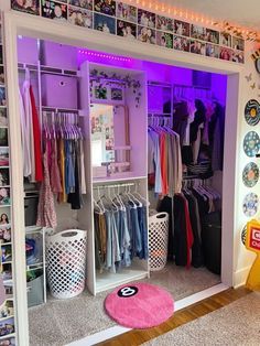 a closet with lots of clothes and other items on display in front of the door