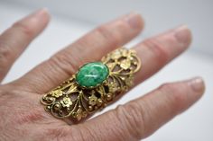 "Beautiful Ornate Filigree flower pattern is a very eye catching statement ring. Measures: 2 1/4\" long- 7/8\" Wide- 1 1/4\" Height Green Stone Measures: 20mm x 12mm Weight; 9.5g The ring is ornate filigree in a bronze metal." Vintage Rings For Spring Gift, Vintage Adjustable Flower Ring For Spring, Adjustable Vintage Flower Ring For Spring, Vintage Flower Ring For Spring Gift, Vintage Green Flower Ring, Vintage Spring Wedding Jewelry, Gold Vintage Jewelry For Spring, Spring Vintage Gold Jewelry, Vintage Onyx Ring