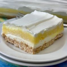 a piece of cake sitting on top of a white plate next to a plastic container