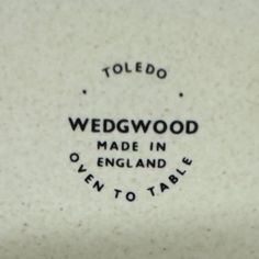 wedgwood made in england is written on the side of a white vase with black lettering