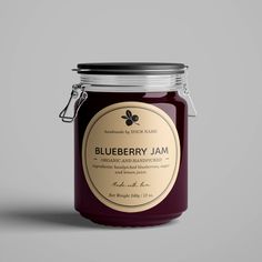 a jar of blueberry jam on a gray background