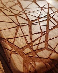 a wooden cutting board with geometric designs on it