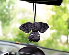 an elephant ornament hanging from the dashboard of a car