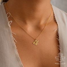 Introducing our exquisite Heart Initial Gold Necklace, a radiant masterpiece that transcends mere jewelry to become a cherished symbol of love and individuality. Crafted with unparalleled attention to detail, this enchanting necklace features a delicately designed heart pendant adorned with your chosen initials, creating a stunning fusion of personalization and romance that captivates the senses. For those who appreciate the beauty of simplicity, our Custom Letters Minimalistic Necklace offers a Wedding Necklace With Heart Charm, Spiritual Heart Pendant Necklace For Anniversary, Spiritual Heart-shaped Necklace For Anniversary, Spiritual Heart Shaped Necklace For Mother's Day, Spiritual Heart Pendant Necklace For Mother's Day, Spiritual Heart Necklace For Mother's Day, Mother's Day Spiritual Heart Pendant Necklace, Valentine's Day Wedding Heart Necklace With Initial Pendant, Valentine's Day Wedding Initial Pendant Heart Necklace