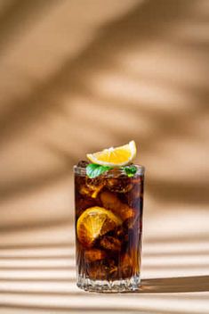 a glass filled with ice and lemon slices