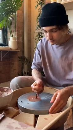 a man is making something with his hands