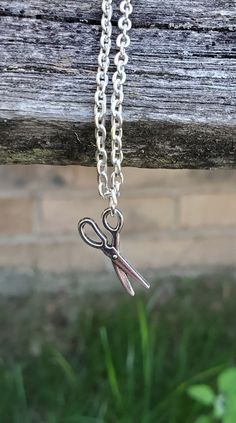 This cute, necklace has a scissors charm and would make a great gift for someone who loves to quilt or sew! The charm and chain are a silver color. The scissors measures 3/4 inch and you can choose the length of the necklace at checkout. This would make a great gift for a birthday, an anniversary, Christmas or any other occasion. All jewelry items come in a gift box. Handmade Pendant Charm Necklaces For Birthday, Handmade Pendant Charm Necklaces For Birthdays, Handmade Pendant Charm Necklace For Birthday, Novelty Necklace With Lobster Clasp For Gift, Handmade Silver Charm Necklace For Birthday Gift, Novelty Charm Necklaces For Gifts, Novelty Pendant Charm Necklace For Gift, Novelty Pendant Charm Necklace As Gift, Novelty Pendant Charm Necklace Gift