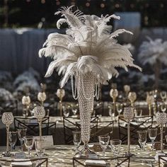 a table topped with lots of tables covered in white feathers