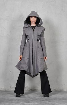 "♥ EXPRESS worldwide shipping - buy your favorite piece today and wear it within just 1-3 days upon shipping ♥ This gray winter coat with a zip-up face shield will keep you safe and cozy! With its shoulder accents and waist belt the coat is extremely flattering to any body shape! ♥ Material: Wool, Viscose lining, Plastic Shield, Plastic Zipper ♥ Available sizes: XS-XL Before placing your order, please consult the Size Chart: www.etsy.com/shop/gizda/policy ♥ This piece has been designed and indiv Fitted Hooded Gray Outerwear, Fitted Gray Hooded Outerwear, Gray Fitted Outerwear With Drawstring Hood, Fitted Hooded Parka With Pockets, Fitted Hooded Military Outerwear, Fitted Military Style Hooded Outerwear, Fitted Hooded Parka For Workwear, Gray Military Style Outerwear For Fall, Gray Winter Coat