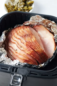 the ham is wrapped in foil and ready to be cooked