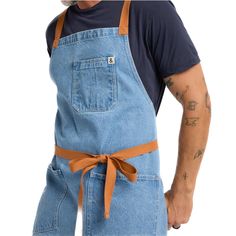 a man wearing an apron and hat with his hands on his hips