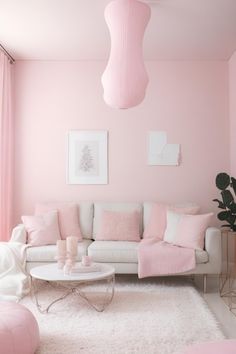 a living room with pink walls and white furniture