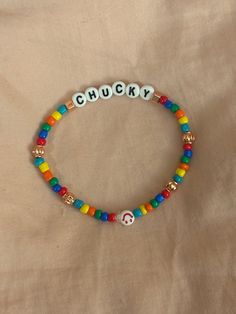 a colorful bracelet with the word chucky spelled in white letters on top of it