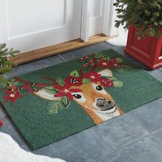 a christmas door mat with a deer's head on it