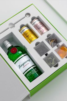 an open green box containing bottles of alcohol