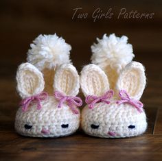 two crocheted bunny slippers with pink bows on the ears and feet, sitting next to each other