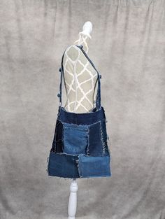 a mannequin wearing a denim skirt with holes in the front and bottom part