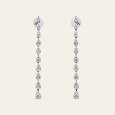 A dramatic row of diamonds will have you ready for any elegant soiree. The Pear-Shaped Diamond Drop Earrings feature 5.72 carats of dangling diamonds that sparkle and glimmer around the wearer’s face. We love a pear-shaped stone’s combination of curves and sharp edges. Stack this glamorous earring pair with tinier studs and hoops to make them more casual. Details18K White Gold5.72 Carats of Pear-Shaped DiamondsDiamond Quality F-G color, VVS-VS ClarityLength: 2.25 inchesManufactured in Italy Luxury Silver Teardrop Earrings Fine Jewelry, Luxury Pear-shaped Bridal Earrings With Elegant Design, Luxury Pear-shaped Polished Teardrop Earrings, Luxury Pear-shaped Jewelry For Party, Luxury Dangle Teardrop Earrings For Pierced Ears, Luxury Modern Teardrop Earrings For Women, Luxury Formal Drop Earrings For Pierced Ears, Luxury Elegant Teardrop Earrings With Diamond Accents, Luxury Silver Teardrop Drop Earrings